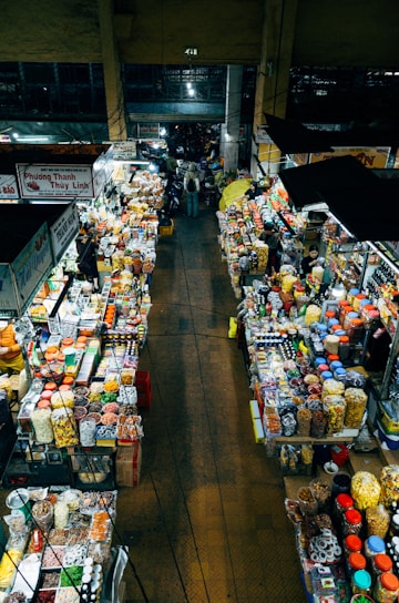 A view of a bustling market with various spices and packaged goods.