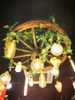 A rustic dining area featuring a warm, vintage-style chandelier casting inviting shadows.