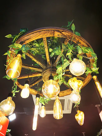 Warm farmhouse chandelier hanging above a rustic wooden dining table.