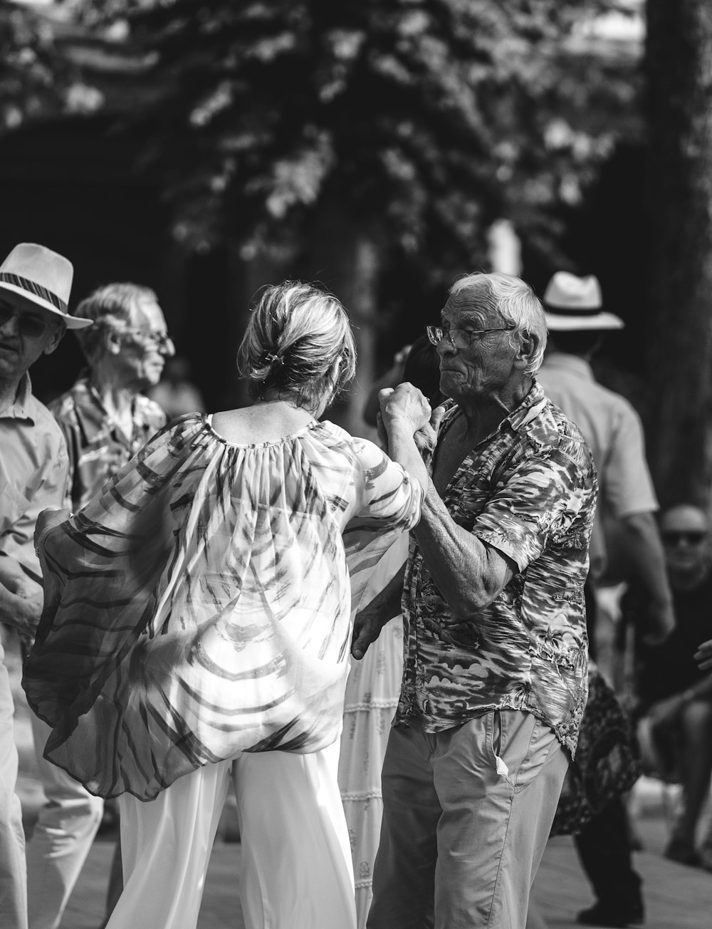 grayscale photo of a man and woman dancing