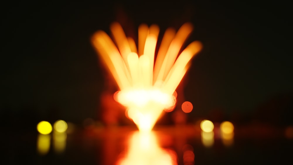 a blurry photo of a lit object in the dark