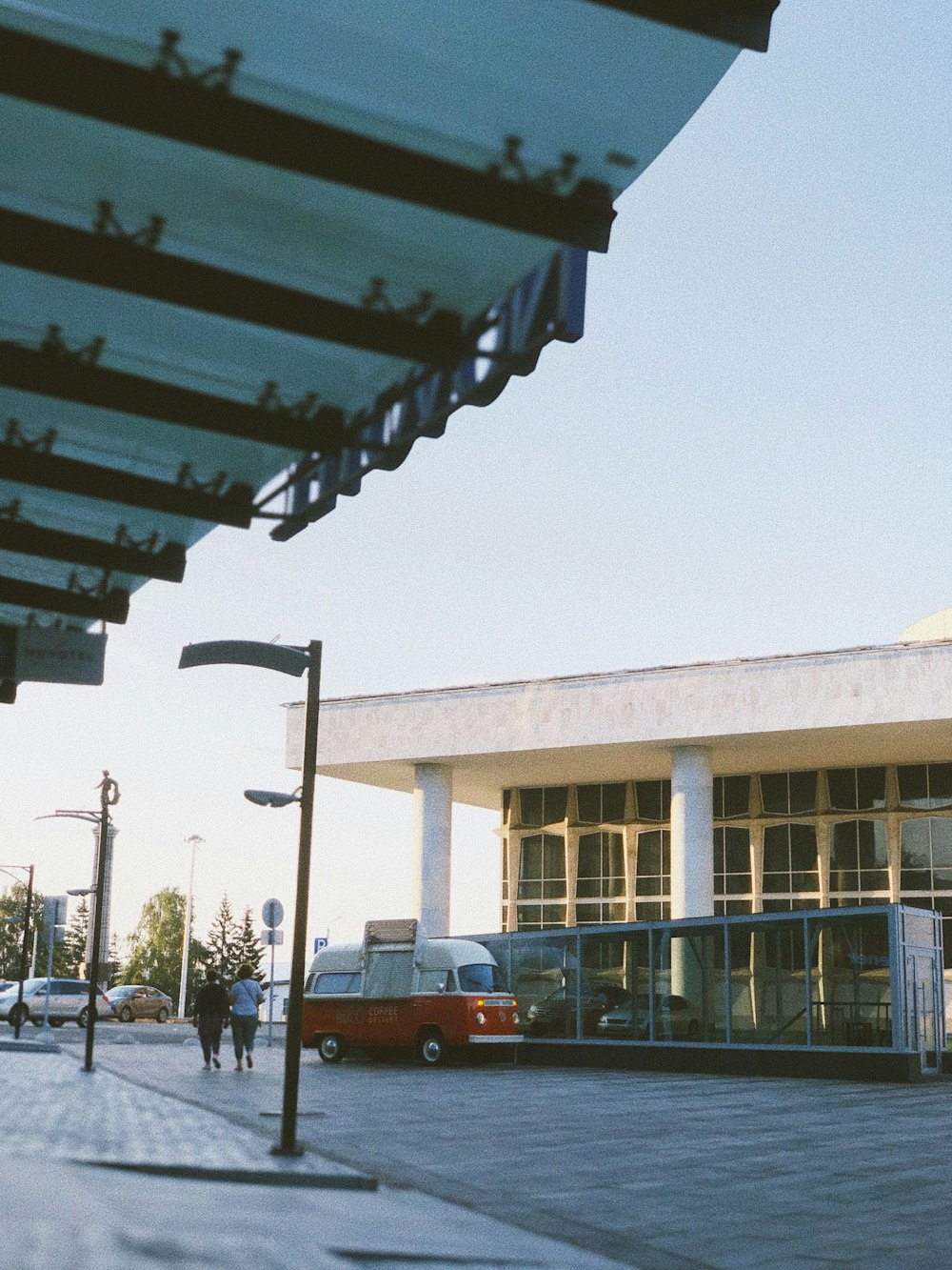 waiting shed near white and red bus