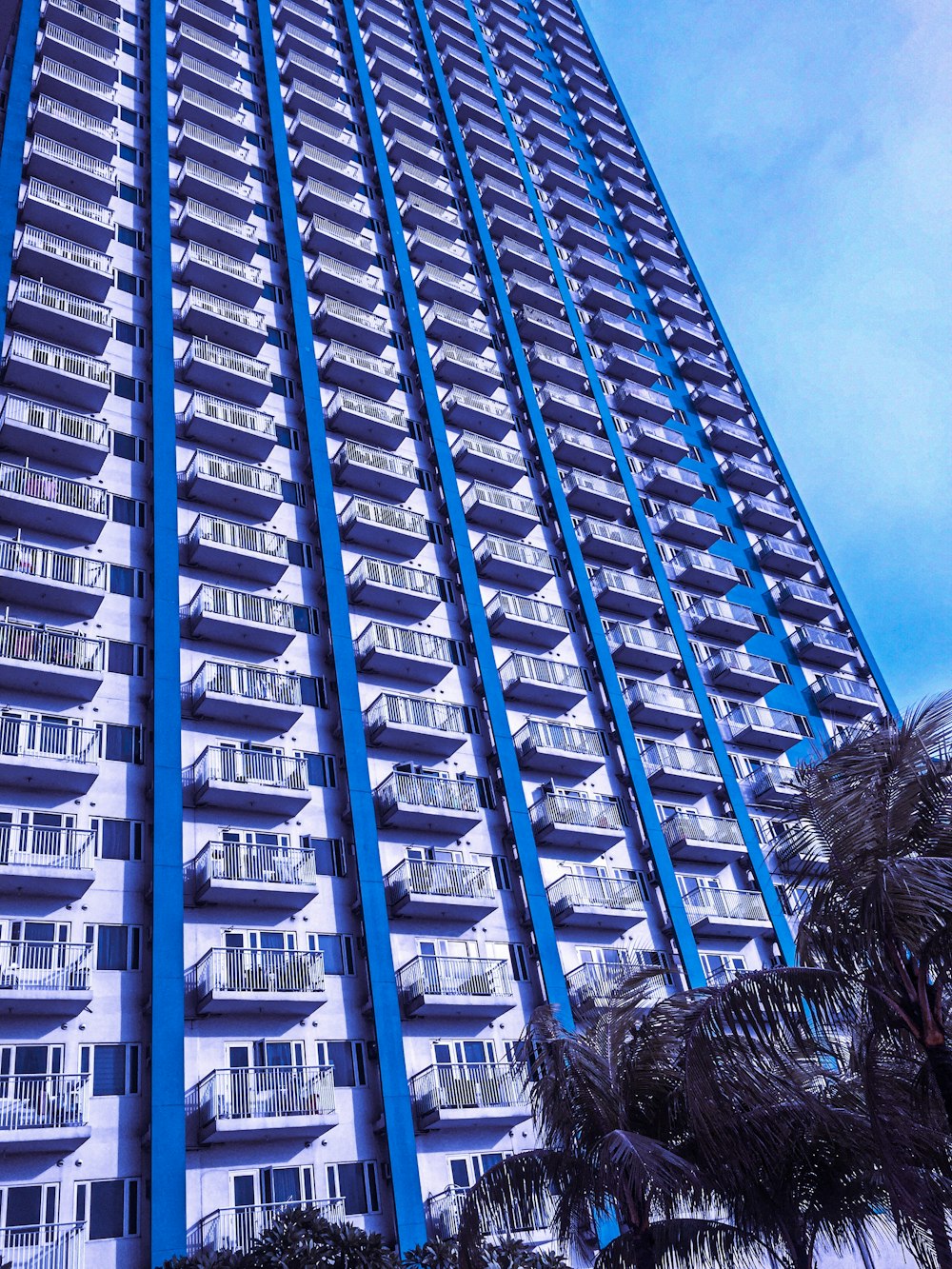 view of white and blue painted apartment complex