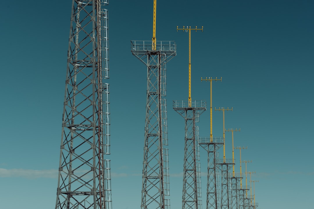 lined electric towers at daytime