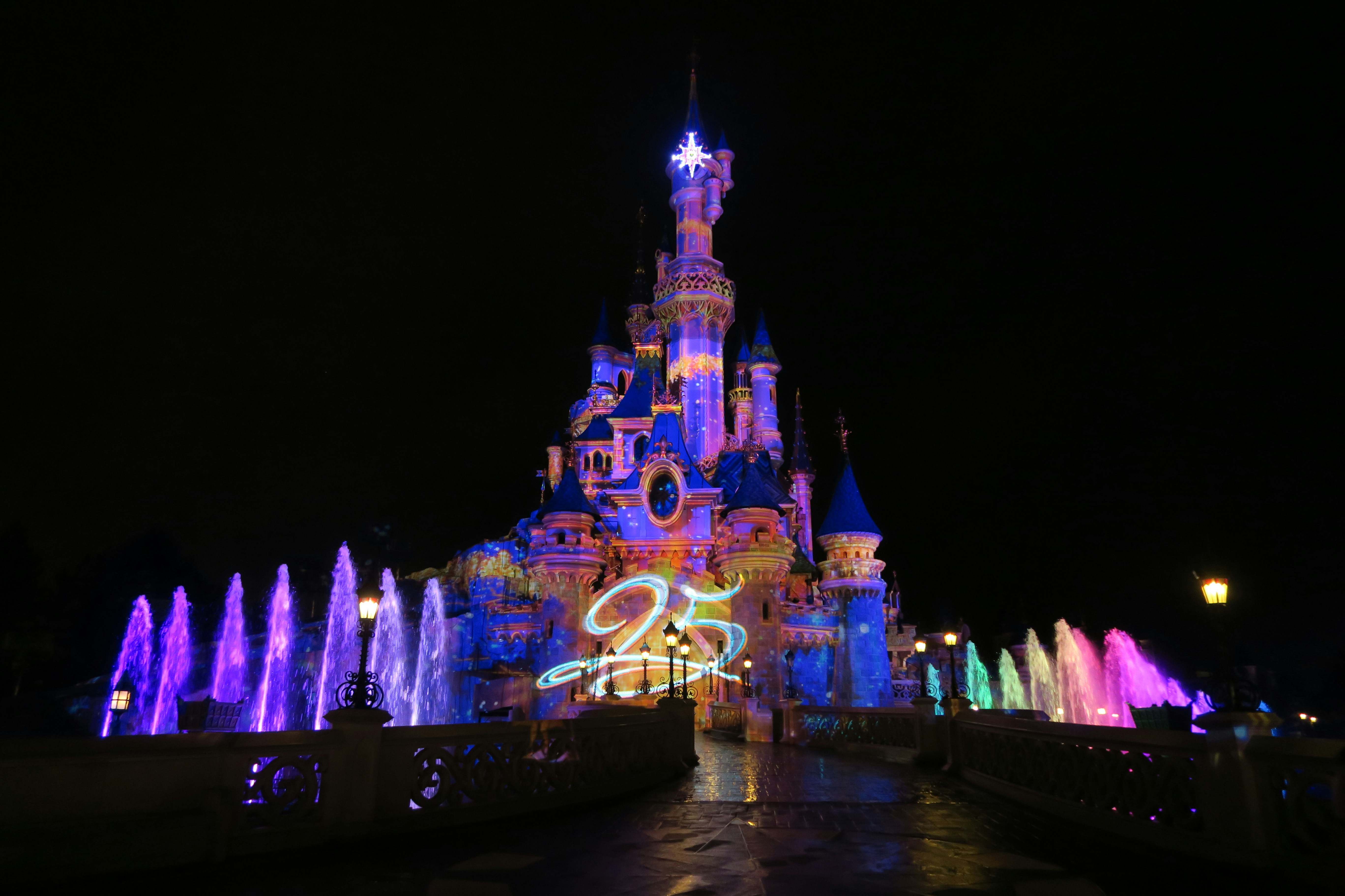 view of lighted Disneyland castle at night