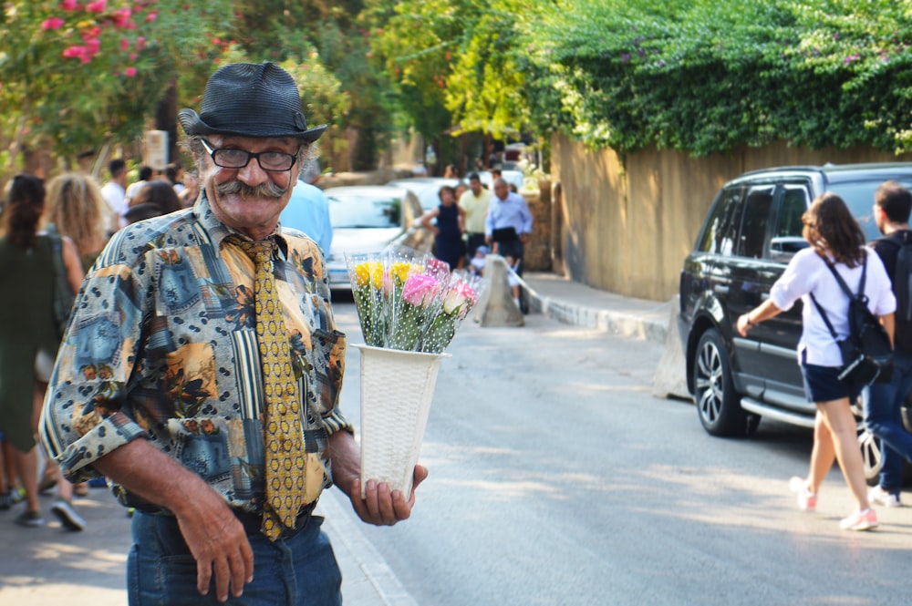 man holding flowers during daytime