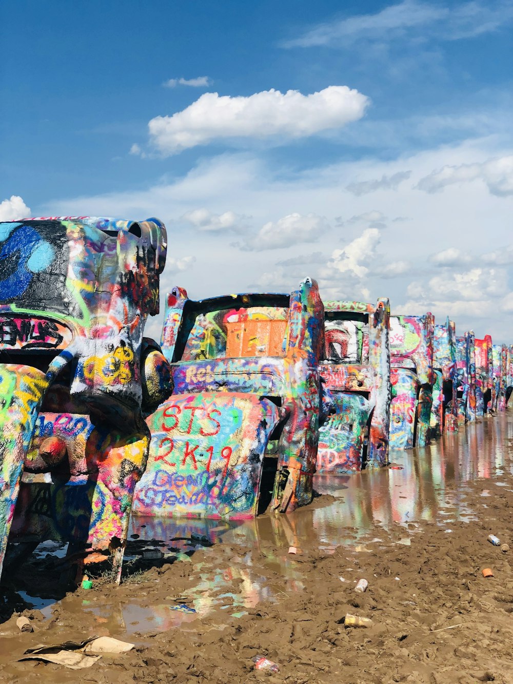 a row of parked cars covered in graffiti