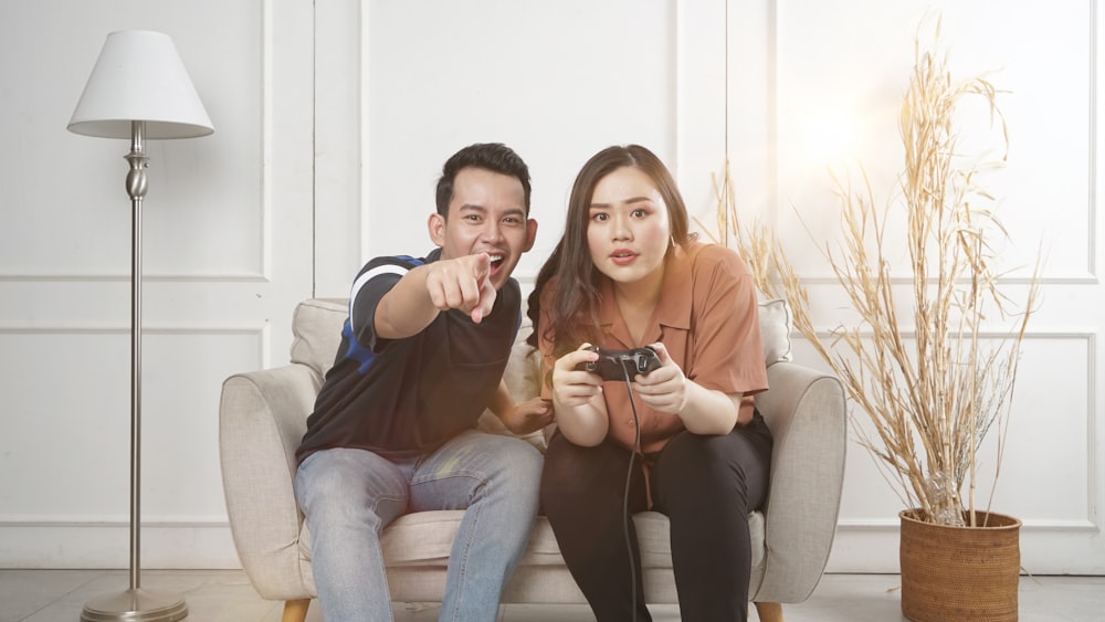 man and woman siting on sofa chair