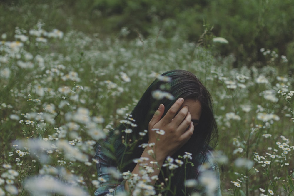 woman near white petaled flowers