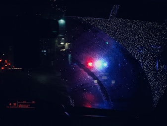 a close up of a car's rear view mirror at night