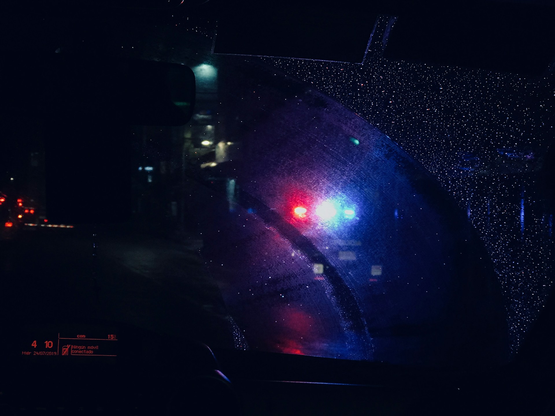 a close up of a car's rear view mirror at night