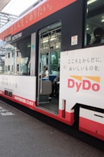 A happy passenger stepping into a comfortable ohkan car on a sunny city street.