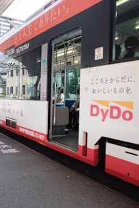 A happy passenger stepping into a comfortable ohkan car on a sunny city street.