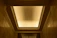 Close-up of a beautifully finished drywall ceiling with soft lighting.