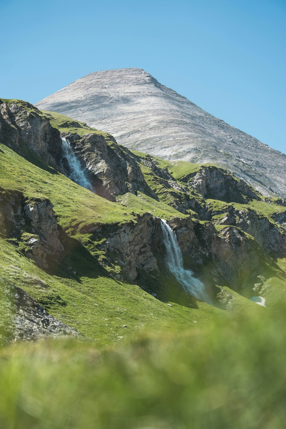 landscape photography of mountain range under clear blue sky