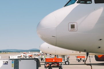 white airplane under clear blue sky