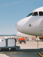 white airplane under clear blue sky