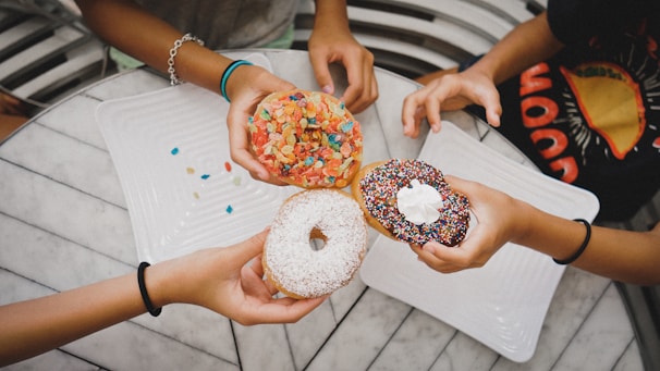 A happy family enjoying mini donuts together.