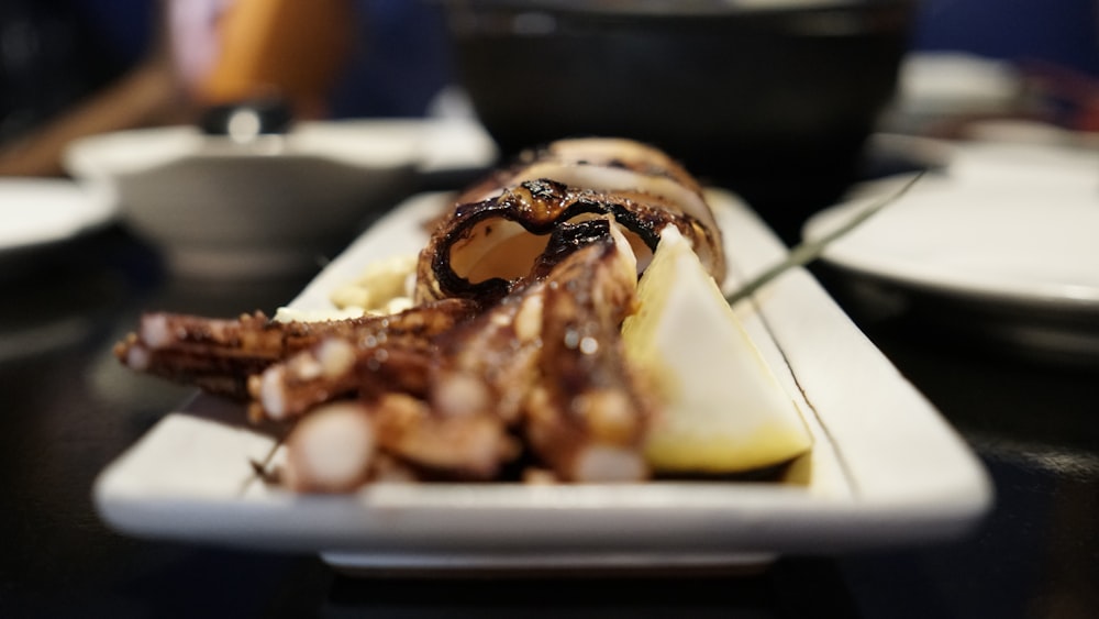 grilled squid on white ceramic plate