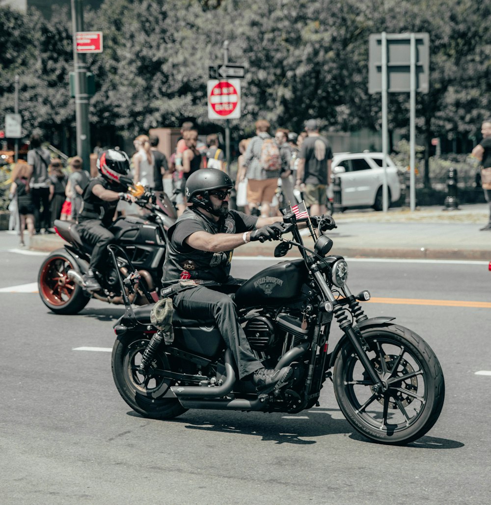 shallow focus photo of man riding cruiser motorcycle