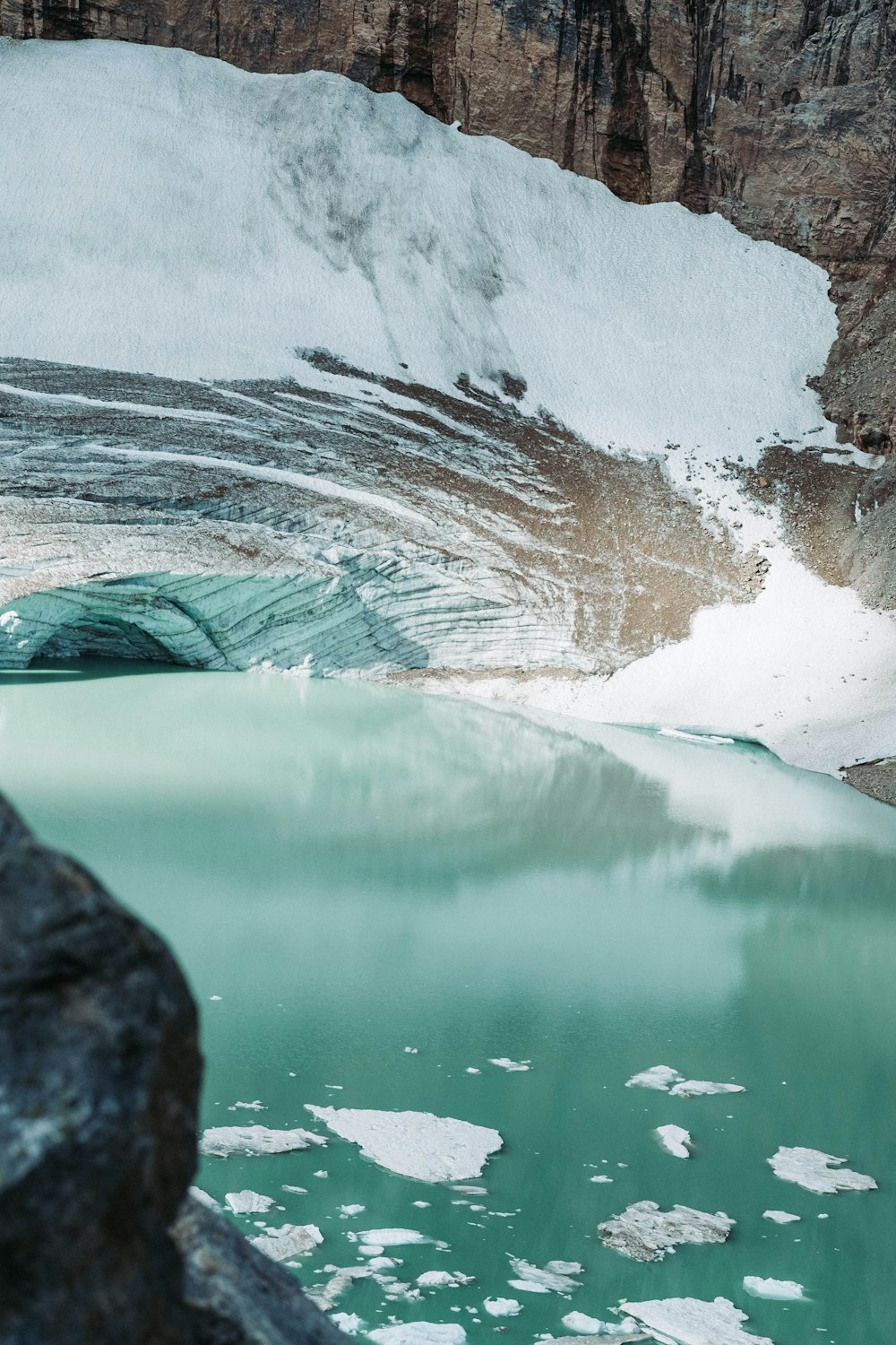 a large glacier with a mountain in the background