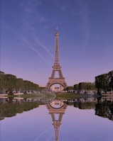 the eiffel tower is reflected in the water