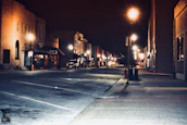 an atmospheric shot of a quiet street in metro manila at night with glowing street lamps