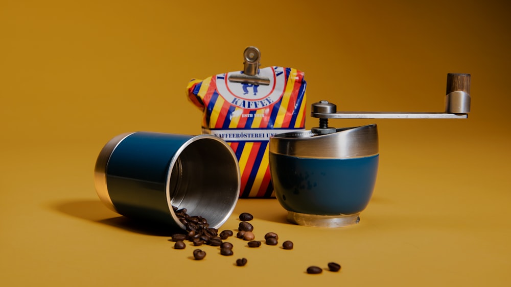 two silver-and-blue coffee beans grinder