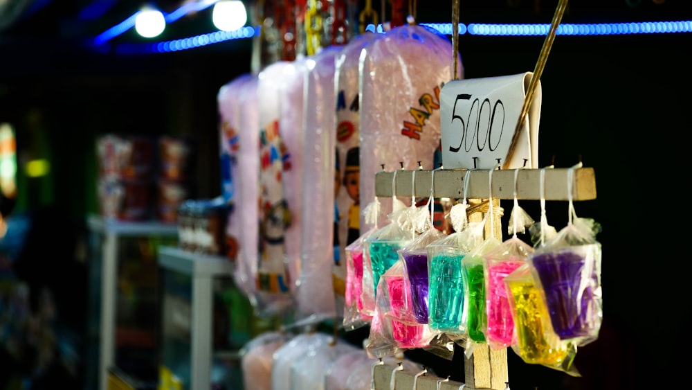 a bunch of bags of candy hanging from a rack