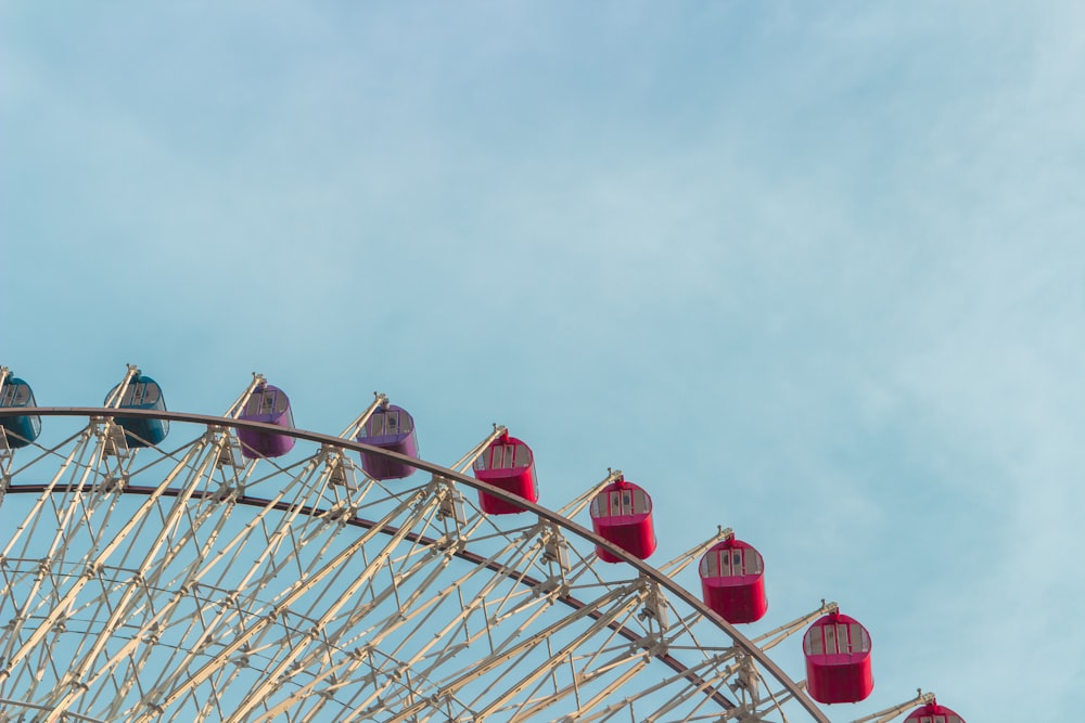 red and white ferris wheel at daytime close-up photography