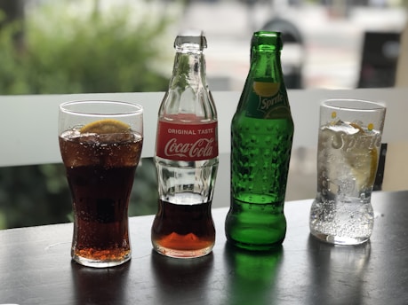 Refreshing non-alcoholic beverages in stylish glass bottles on a table.
