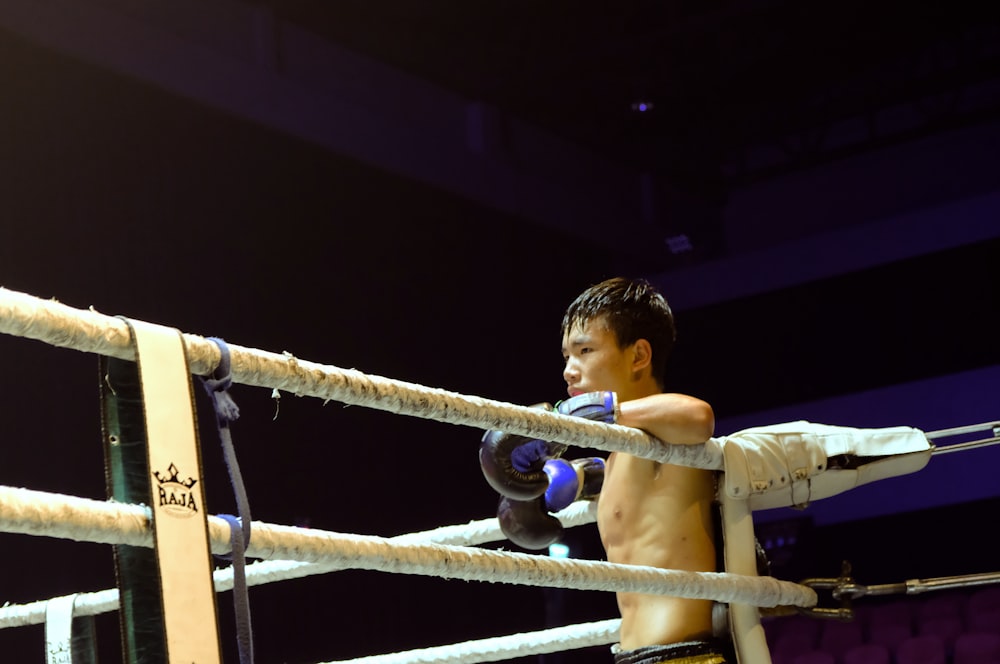 men wearing blue gloves in a boxing ring close-up photography