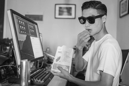 Confident professional working at a desk with healthy snacks and water nearby.