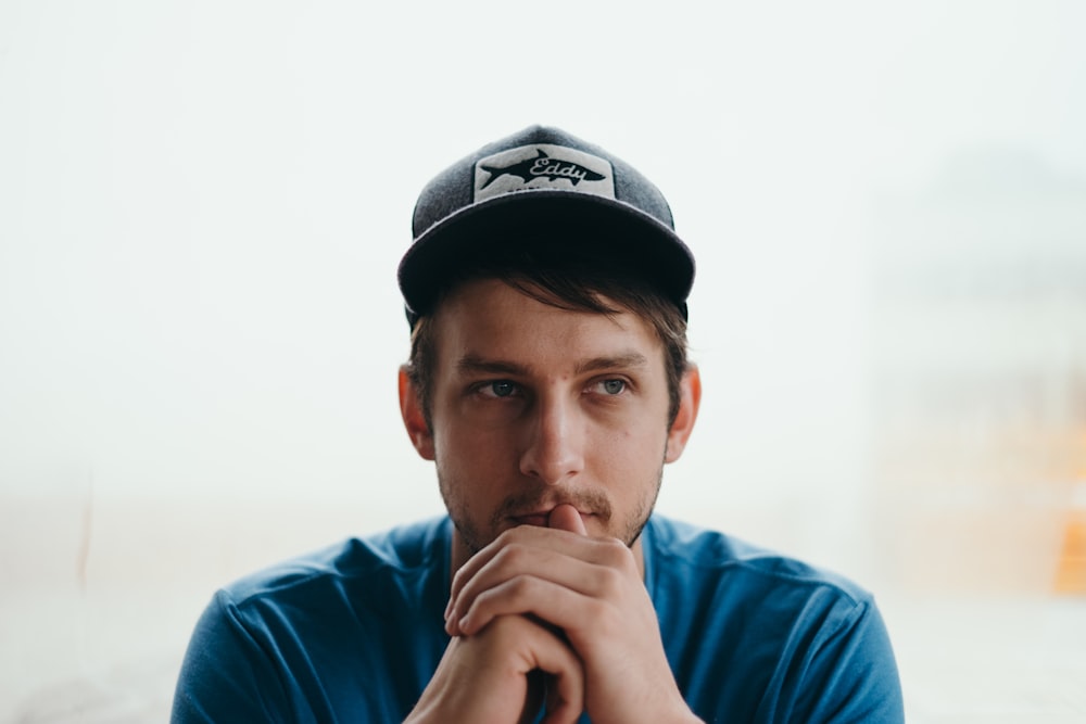 men wearing black cap close-up photography