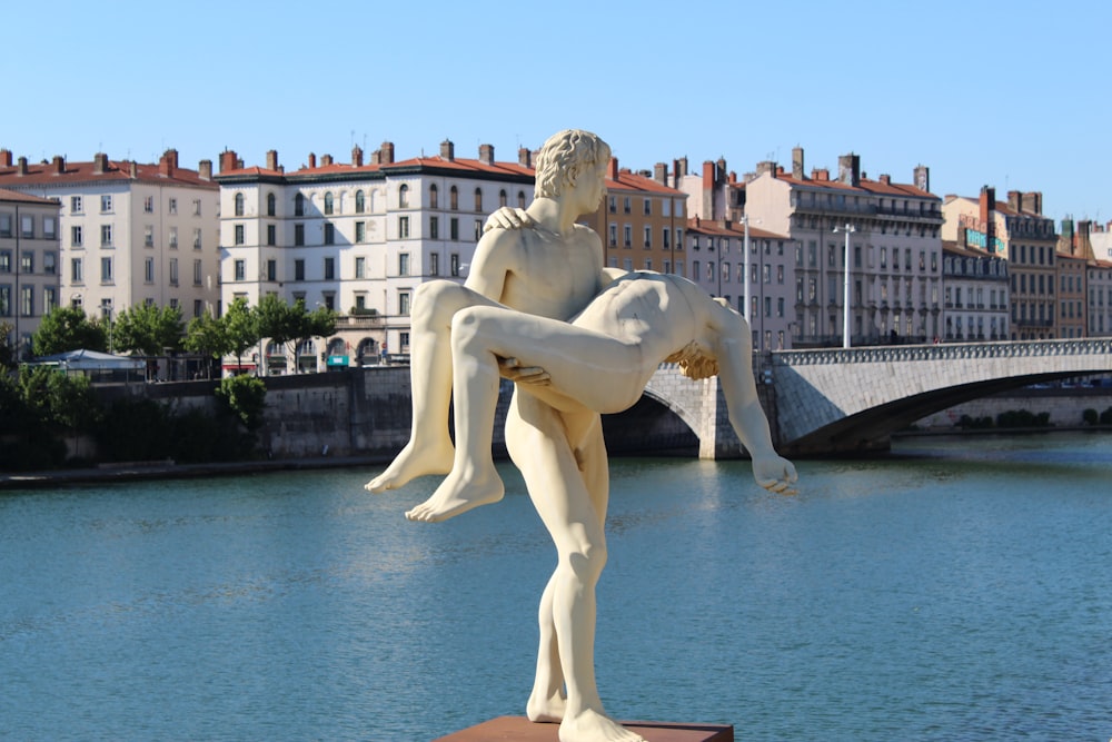 man holding woman statue