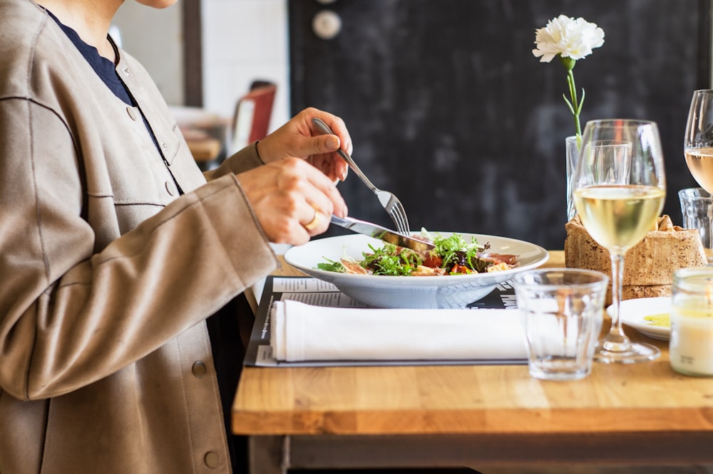 person eating vegetable salad