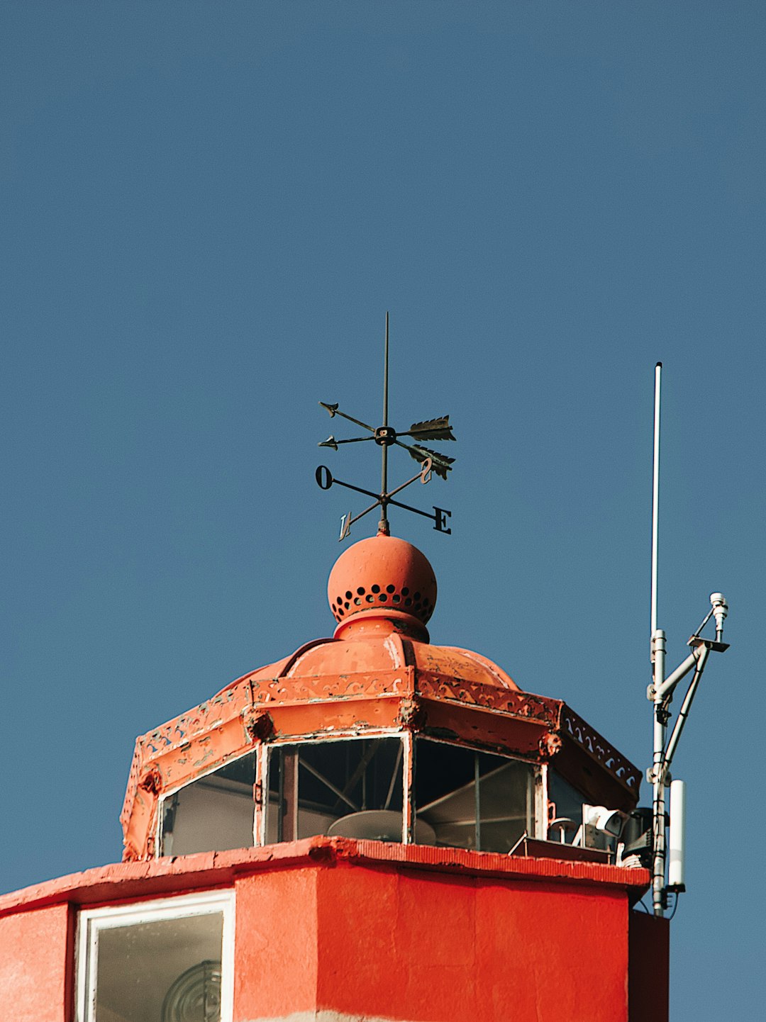red building with brown arrows weathervane