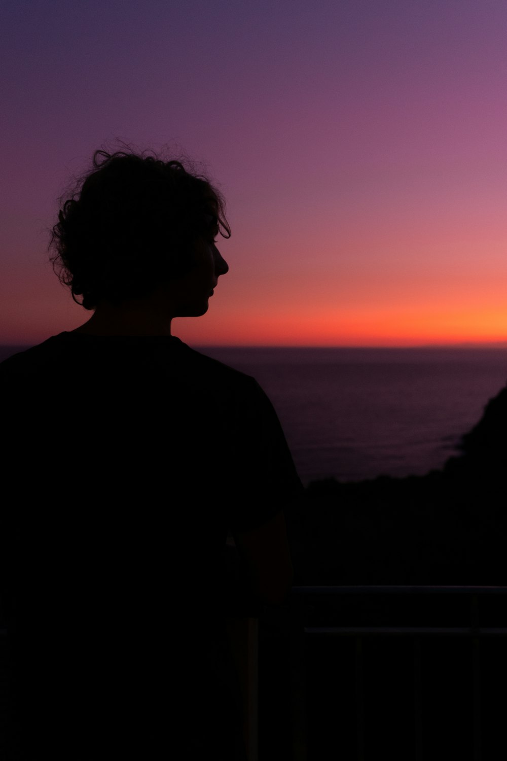 silhouette of man near body of water during golden hour