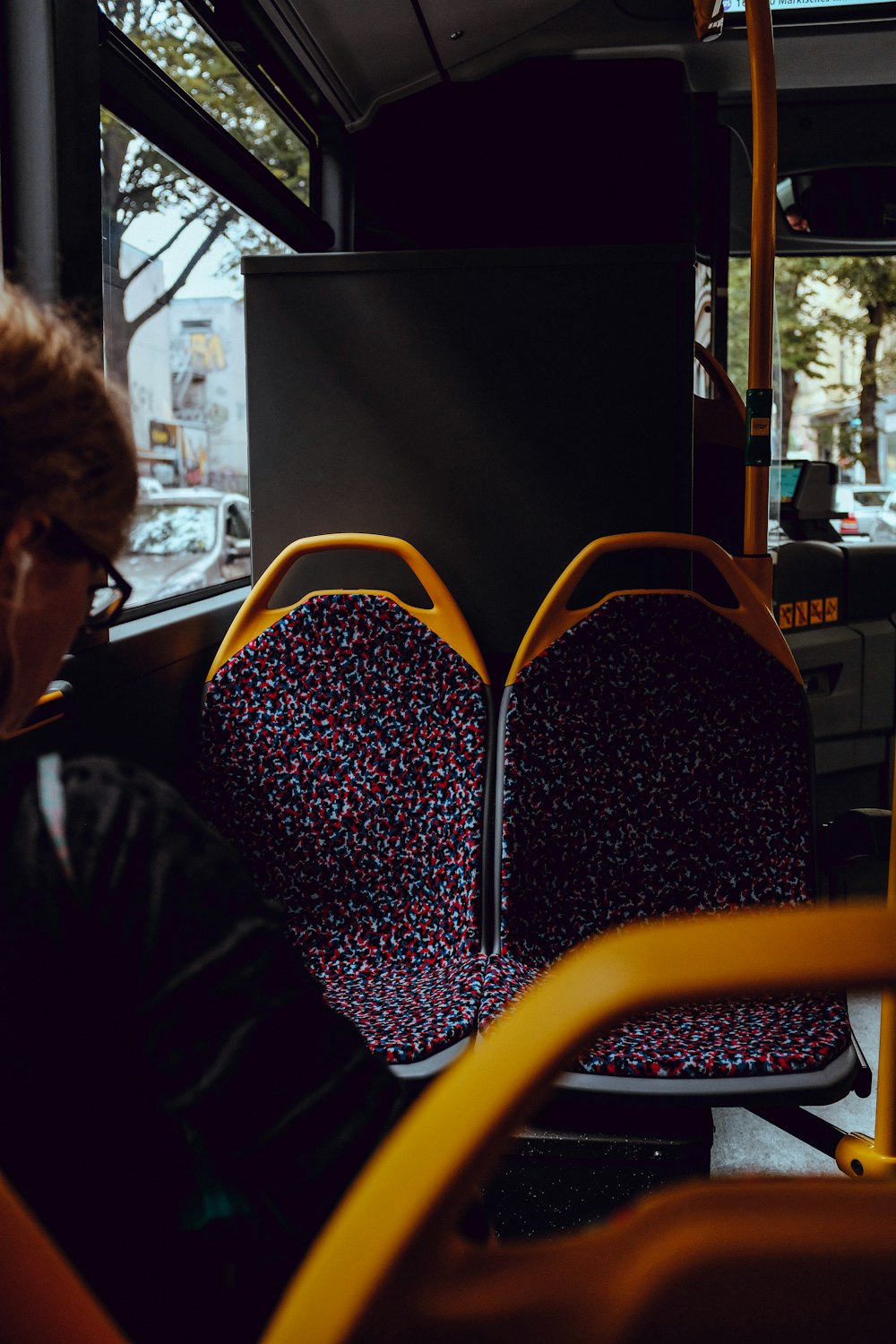 a woman sitting on a bus looking out the window