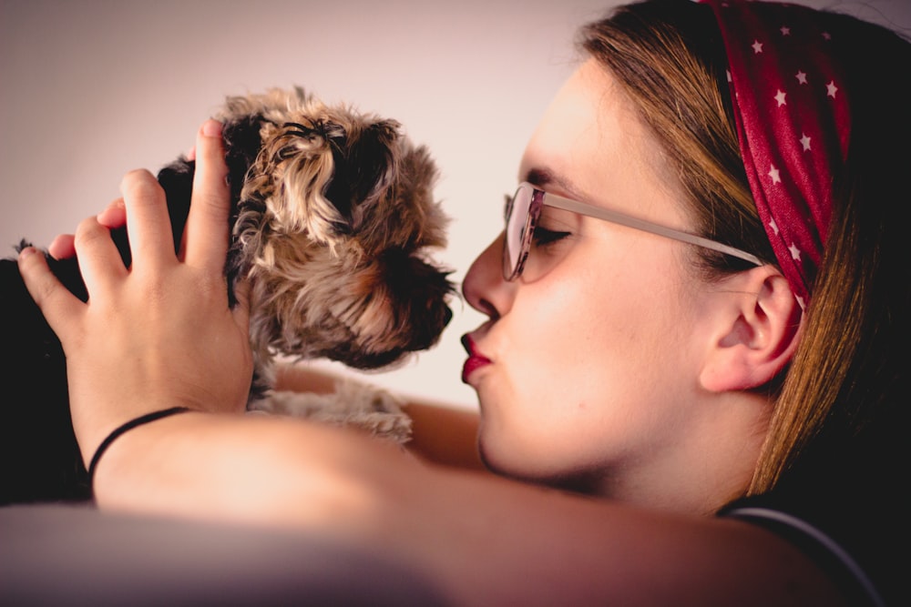 woman kissing dog