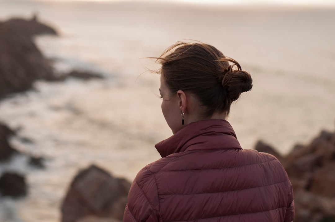 women wearing red jacket close-up photography