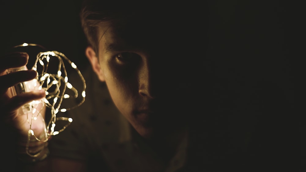 person holding white string light