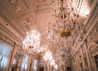 white and brown uplight chandelier