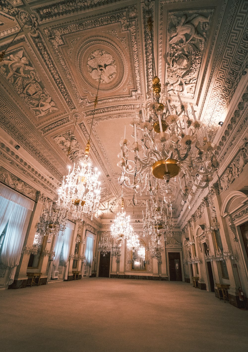 white and brown uplight chandelier