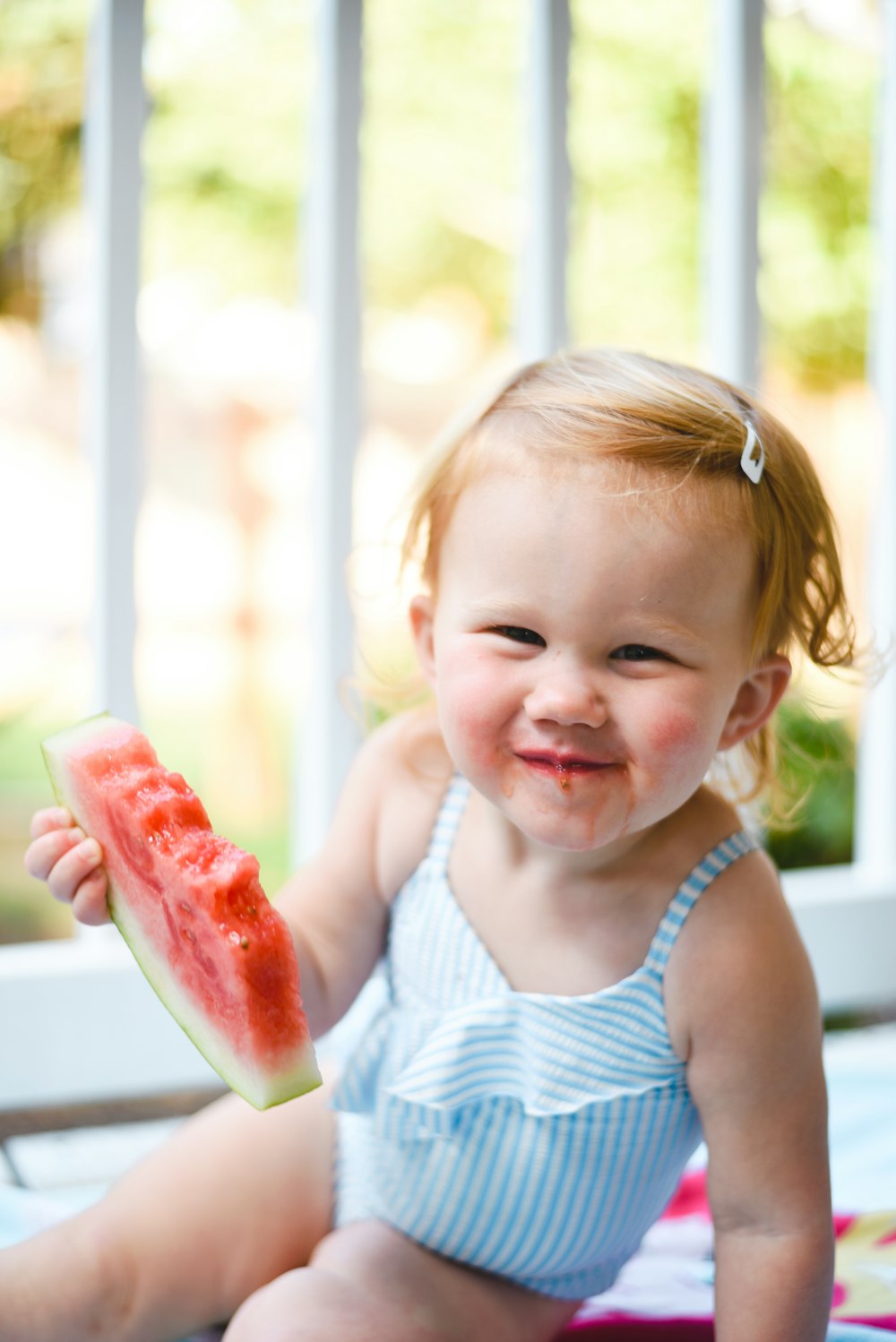 baby eating sliced watermelon
