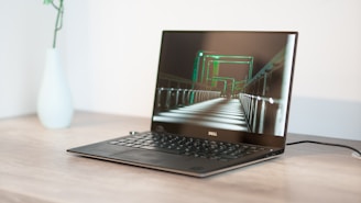 turned-on black Dell laptop computer