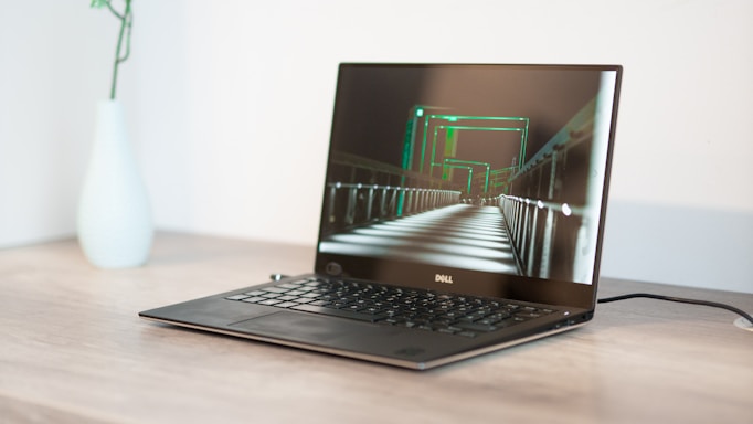 turned-on black Dell laptop computer