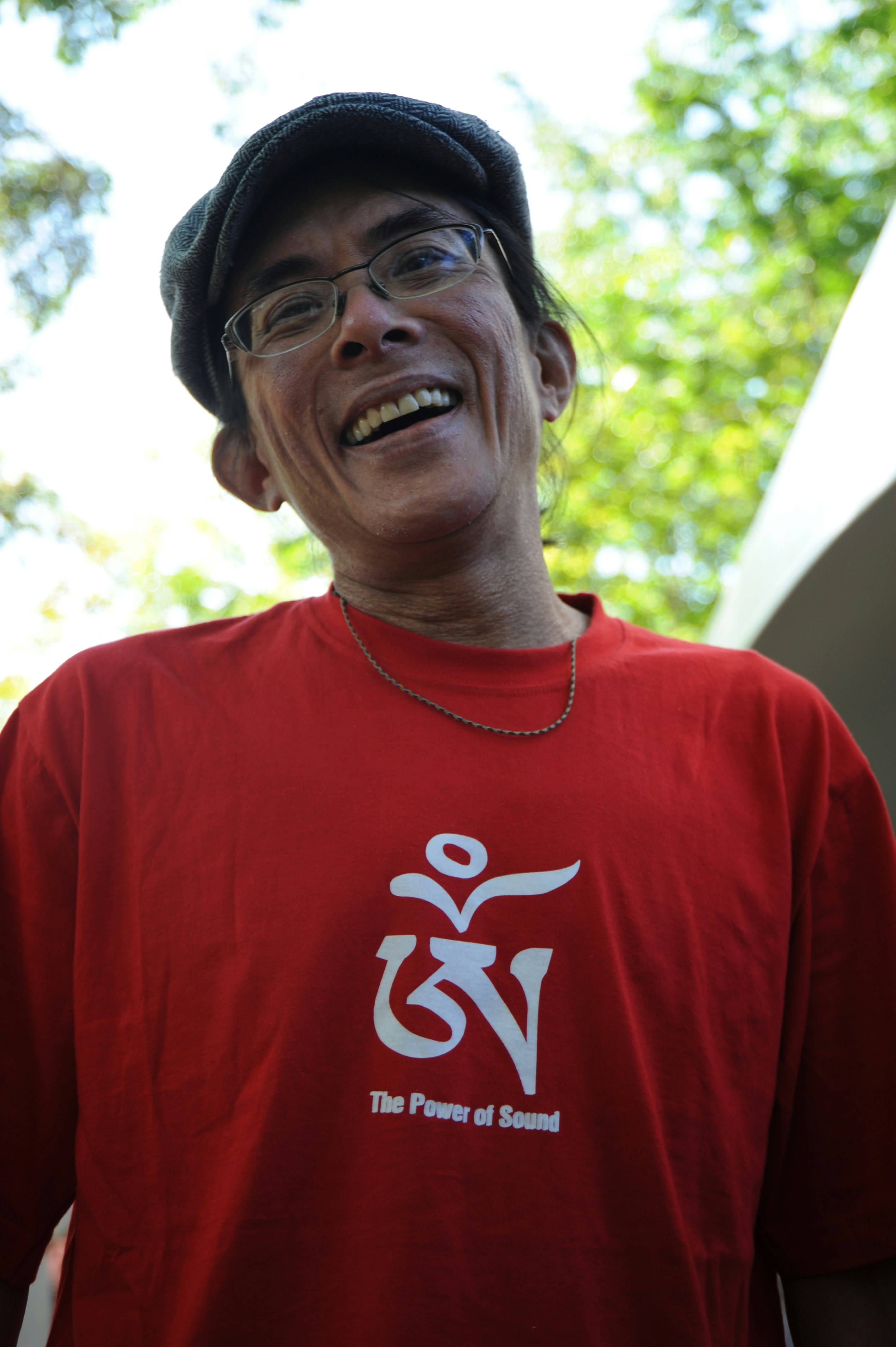 unknown person in red crew-neck top taking selfie outdoors