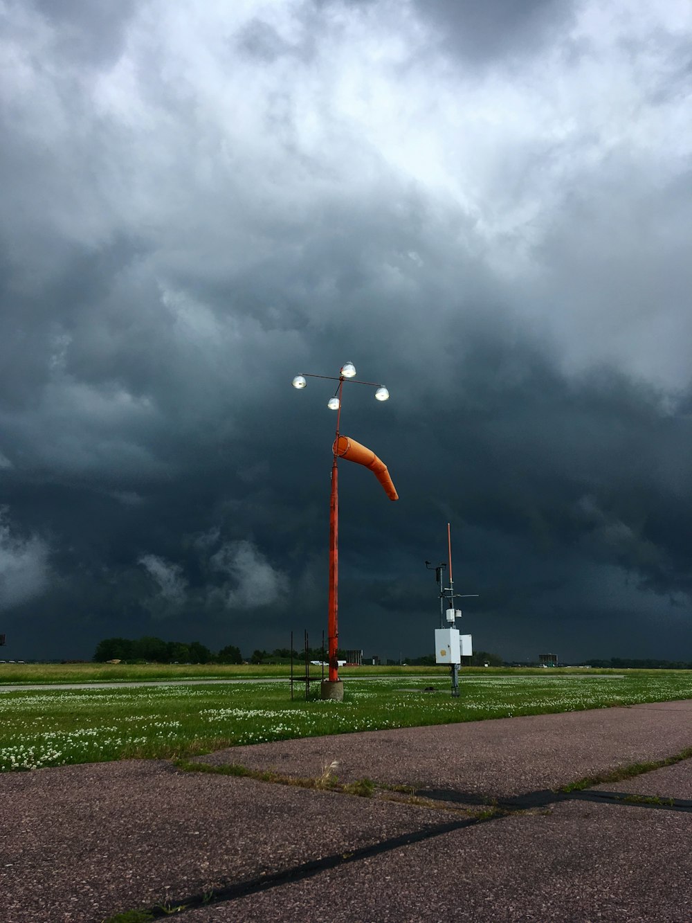 orange and grey street lamp near road