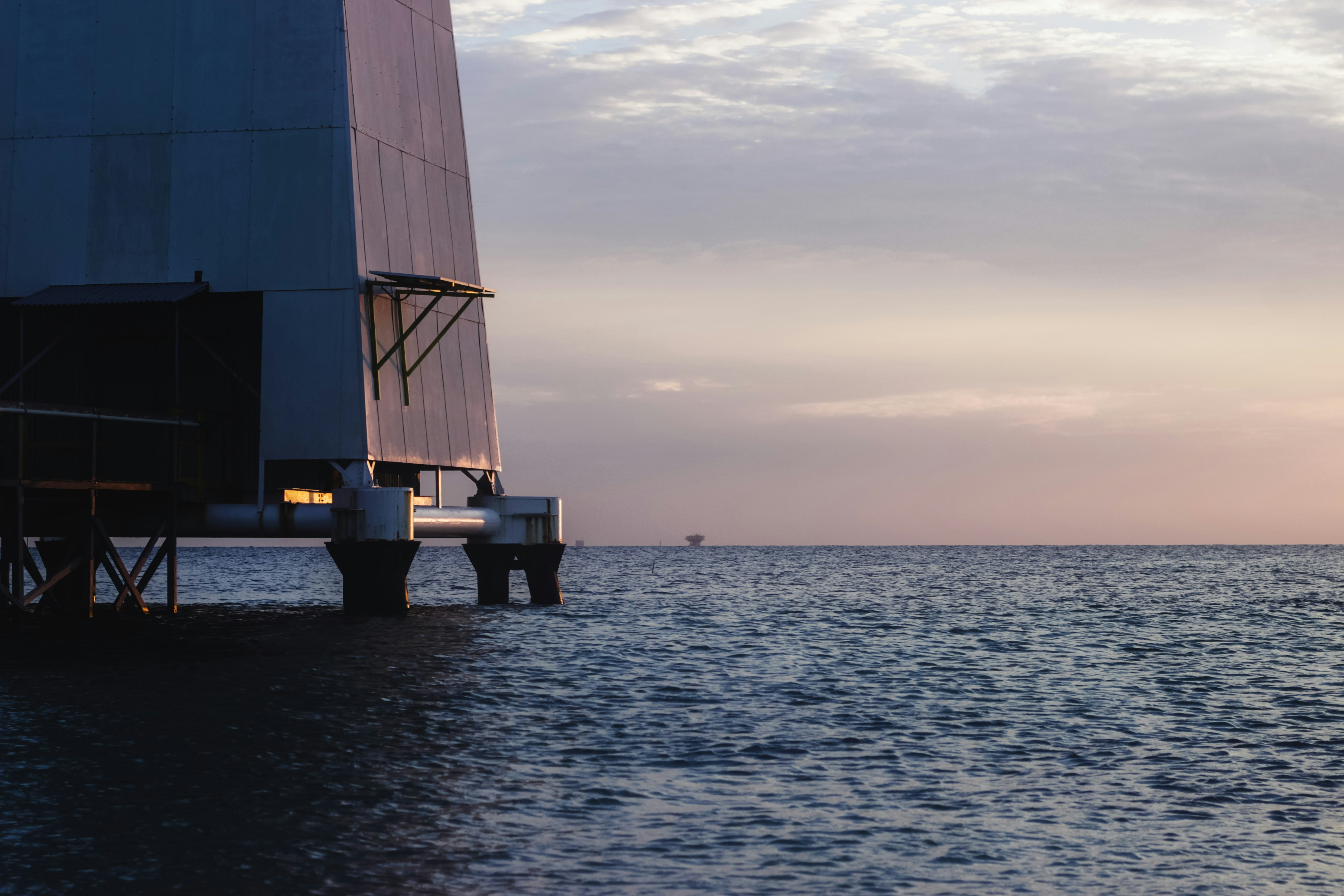 Offshore oil platform structure with steel framework against ocean background